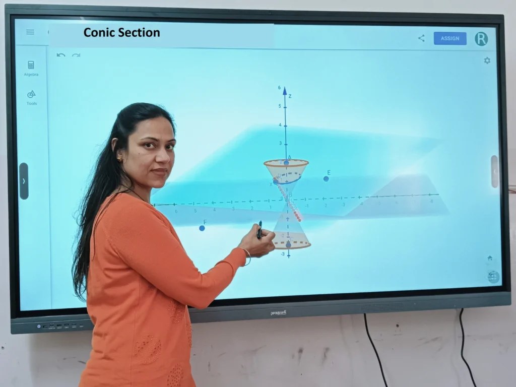 Maths coaching in Chandigarh with Ritu Goyal explaining Conic Section concepts using a smart board, delivering interactive and concept-driven CUET and Applied Maths classroom teaching.
